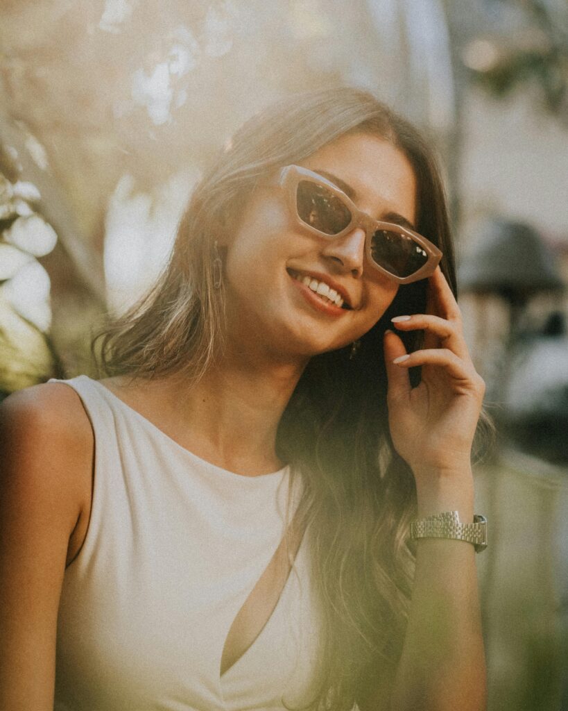 pexels photo 28485825 28485825 A young woman in sunglasses confidently relaxes outdoors on a sunny day in Antalya, Turkey.