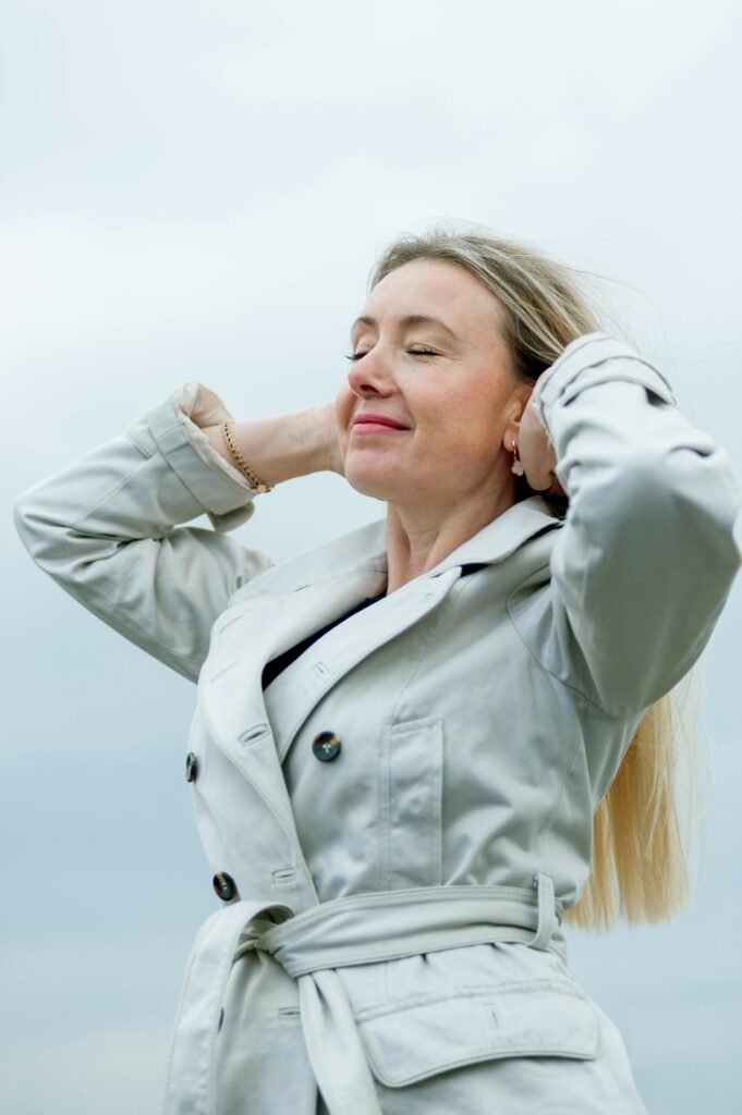 pexels photo 34761441 34761441 Woman enjoying a serene outdoor moment with closed eyes and relaxed posture.