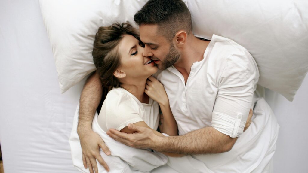 pexels photo 36813274 36813274 A loving couple embracing in bed, capturing intimacy and affection.