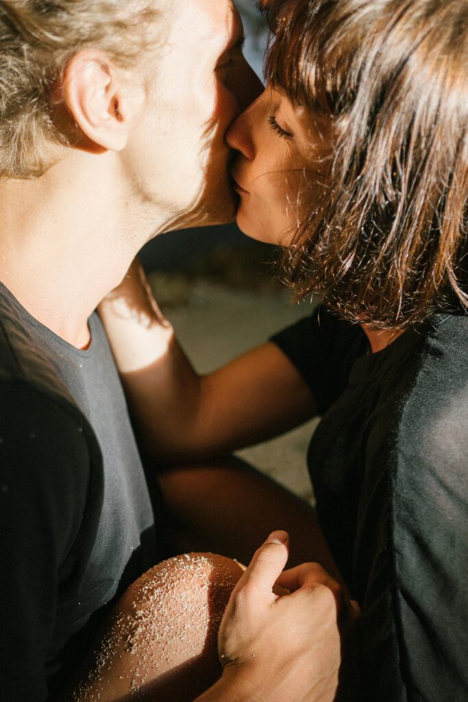pexels photo 7312046 7312046 Close-up of a couple sharing a romantic kiss on the beach.